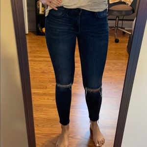 Dark wash skinny jeans with raw hem